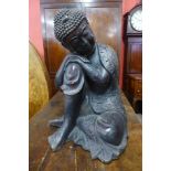 A large oriental bronze figure of a seated deity, 61cms h