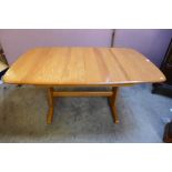 An Ercol Blonde elm dining table