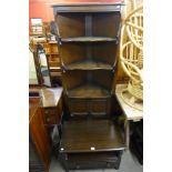 An Ercol dark oak freestanding corner cabinet and TV stand