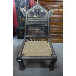 A late 19th/early 20th Century Indian hardwood and brass pida chair, 97cms h, 60cms w, 62cms d