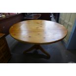 A pine circular kitchen table