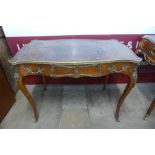 A French Louis XV style mahogany, gilt metal and brown leather topped serpentine writing table