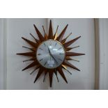 A Metamec teak sunburst wall clock