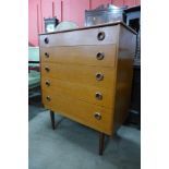 A teak chest of drawers