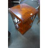 An inlaid yew wood revolving bookcase