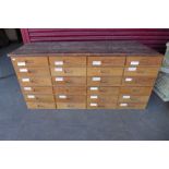 A bank of oak shop drawers