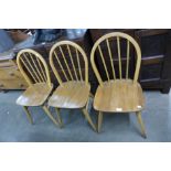 A set of three Ercol Blonde elm and beech Windsor chairs