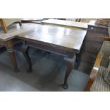 A mahogany draw-leaf table