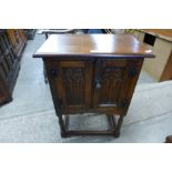 A small carved oak two door cupboard