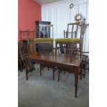 A Younger teak extending dining table and four chairs