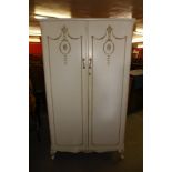 A French style cream and parcel gilt two door wardrobe
