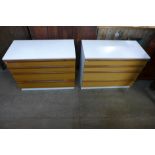 A pair of teak and white laminate chests of drawers