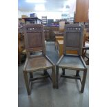 A pair of Arts and Crafts oak hall chairs