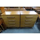 A pair of teak chests of drawers