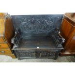 A Victorian Jacobean Revival carved oak monk's bench, 73cms h, 108cms w, 50cms d