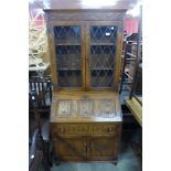 A Jaycee carved oak linenfold bureau bookcase