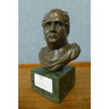 A small bronze bust of Roman Emperor, on green marble socle, 14cms h