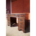 A mahogany and green leather topped pedestal desk, 69cms h, 123cms w, 60cms d