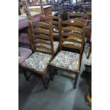 A set of four oak ladderback dining chairs