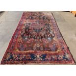 An eastern geometric patterned red ground rug, 314 x 168cms
