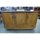 An Ercol Blonde elm and beech Windsor sideboard