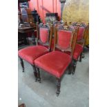 A set of four Victorian carved walnut dining chairs
