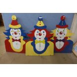 Three vintage painted fairground hoopla clowns