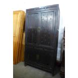 A Chinese carved elm and pine four door cabinet, 161cms h, 84cms w, 47cms d