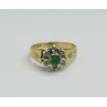 A 9ct gold, emerald and six diamond cluster ring, 2.4g, L