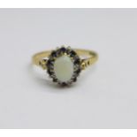 A 9ct gold, opal, ten diamond and ten sapphire cluster ring, 1.8g, O, opal a/f