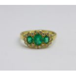 An 18ct gold, emerald and diamond triple cluster ring, 3.3g, N, (centre emerald approximately 4mm