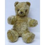 A large Schuco Teddy bear, circa 1930's, straw filled with jointed limbs, glass eyes and tail, 50cm