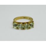 A 9ct gold and four green stone ring, 3.4g, M