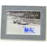A framed signed photograph of ex-F1 driver Jackie Stewart