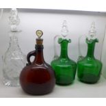A pair of 19th Century green glass decanters, an amber glass Gin decanter and a 19th Century crystal