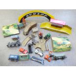 A box of model rail, tin-plate platform, plastic Dunlop bridge, track, die-cast vehicles, etc.