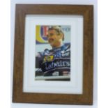 A framed signed photograph of 1992 F1 World Champion Nigel Mansell