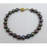 A cultured black pearl bracelet, clasp marked 750