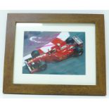 A framed signed photograph of Michael Schumacher driving a Ferrari