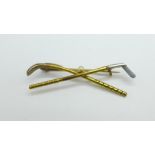 A yellow metal golf brooch set with a pearl, tests as 14/15ct gold, 4.6g