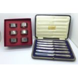 A set of six silver handled knives, boxed and six plated napkin rings