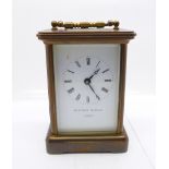 A brass and four glass sided timepiece with key, door loose, 11.25cm