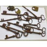 Fourteen antique door keys and three padlocks