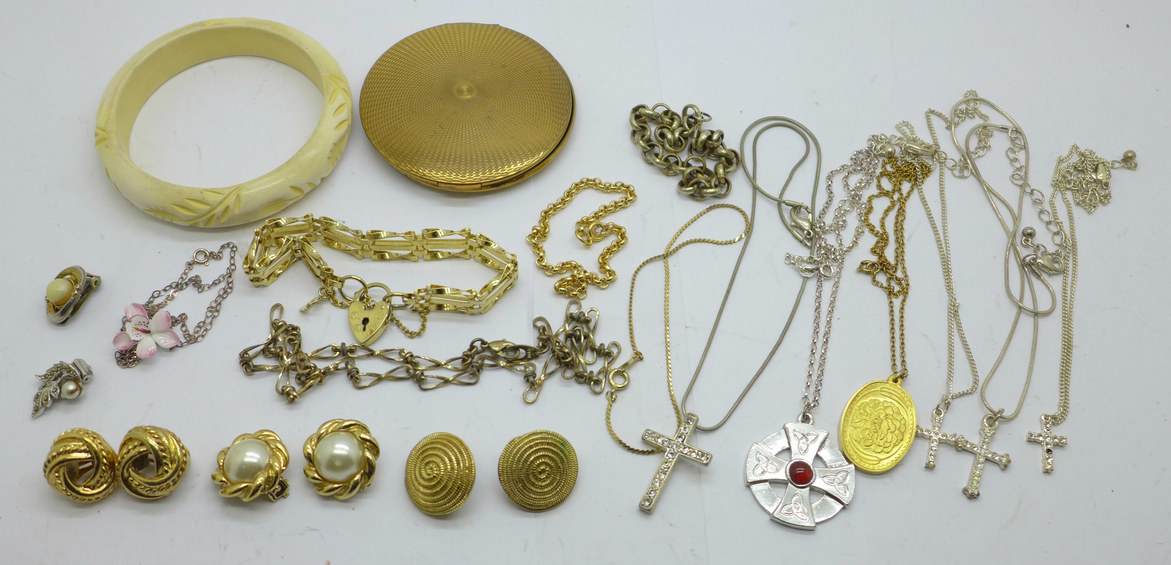 A collection of jewellery and a compact