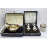 A silver sauce boat, 97g, boxed, a silver salt and pepper pair, 54g, cased, and a silver topped jar,