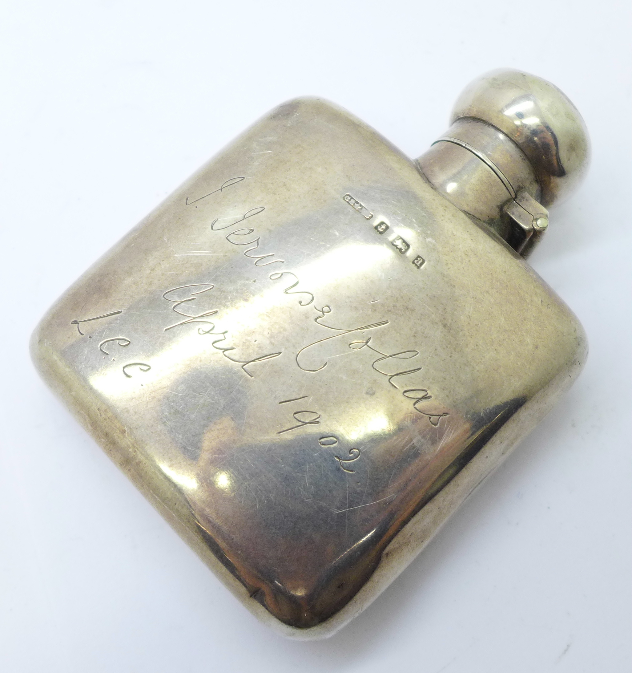 A small silver flask, Birmingham 1900, with inscription dated 1902, 81g, height 93mm, some dents