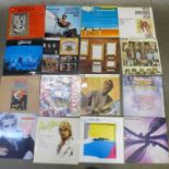 Twenty-five LP records including Mike Oldfield, Paul Simon, Genesis, Little Richard, The Moody