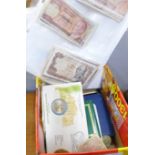 A collection of mixed coins and world banknotes