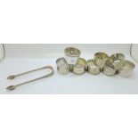 Six silver napkin rings and a pair of silver sugar bows, 198g, and two plated napkin rings, (one