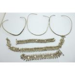 Three silver collars, two white metal bracelets and a white metal necklace